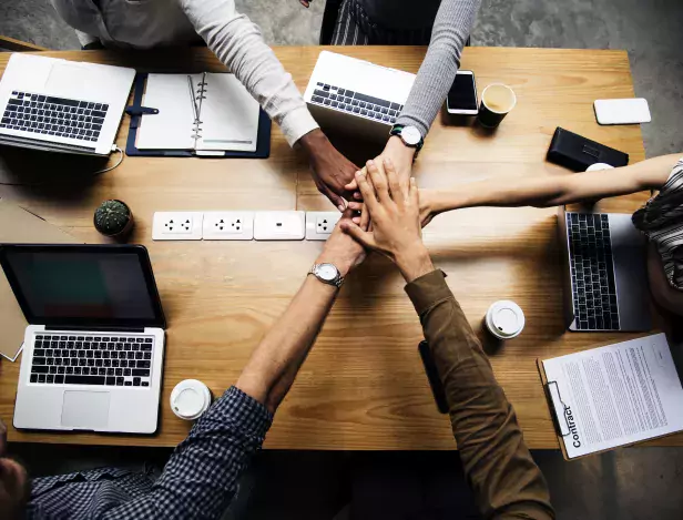 team-of-business-people-stacking-hands