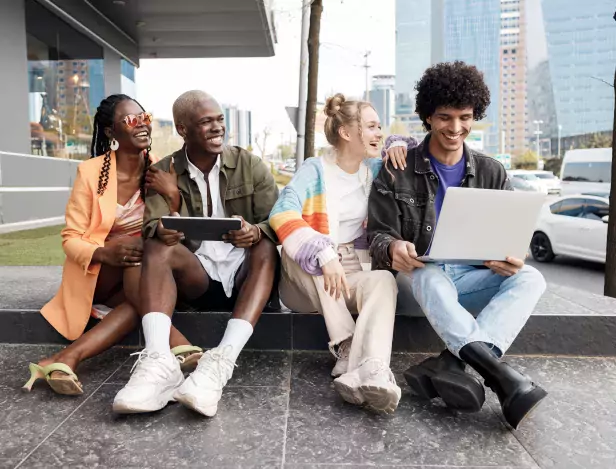 emotional-friends-doing-work-on-laptop-outdoor